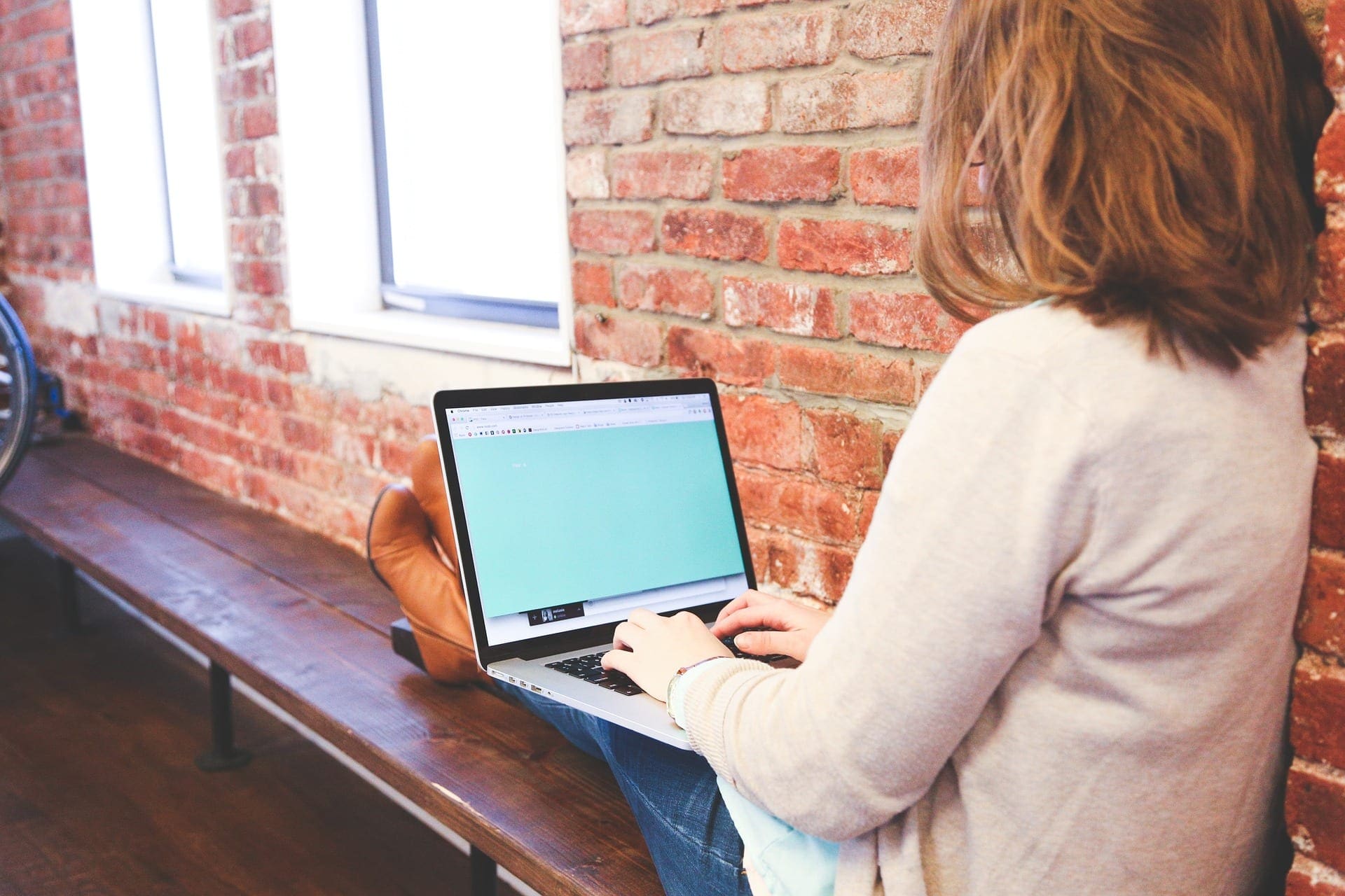 woman using laptop in modern loft building